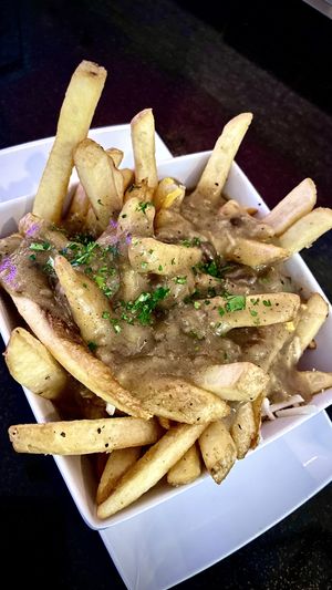 CANADIAN POUTINE
French fries topped with shredded mozzarella and cheddar cheese, smothered in our homemade sausage and mushroom gravy.  at The Modern Vegan in Las Vegas