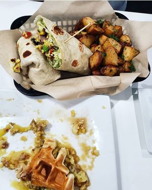 Devoured chicken and waffles next to the breakfast burrito at The Modern Vegan in Las Vegas