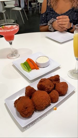 Buffalo cauliflower wings, pineapple mimosa, strawberry margarita😄 at The Modern Vegan in Las Vegas