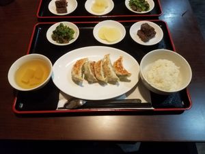 Gyoza set containing Gyozas, rice, veggi soup, pickled radish, a salad containing brokkoli and sea weed, and a five spice mochi type of thing - very yummy. at Ren - Nakagyo Ward in Kyoto
