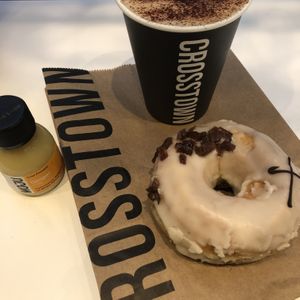 Maple “bacon” doughnut and oat milk decaf cap at Crosstown Doughnuts Vegan in London