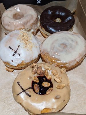 Vanilla, Dark Chocolate Truffle, Rhubarb & Ginger, Cinnamon Scroll, Peanut Butter & Blackcurrant at Crosstown Doughnuts Vegan in London