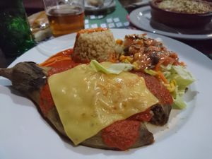 Stuffed aubergine with rice, nuts, vegan cheese at Canadu in Malaga