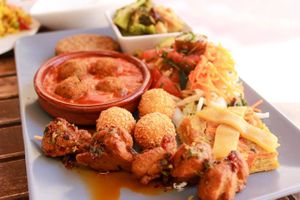 vegan plate (soy balls in tomato sauce, seitan kebabs, soy patty, salad, vegetable gratin, etc.) at El Vegetariano de la Alcazabilla in Malaga