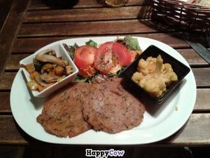 Seitan cutlets, fried vegetables, cauliflower and green salad at El Vegetariano de la Alcazabilla in Malaga
