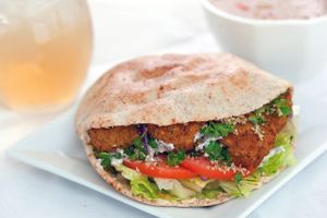 The best falafel sandwich in town,
Mix of lettuce, tomato, Cucumber, and Onion all soaked in our homemade Egyptian Tahina.
then we add the crispy falafel over them in Pita Bread.
All cooked vegan.

 at Four Guys Famous Fries in Koh Samui