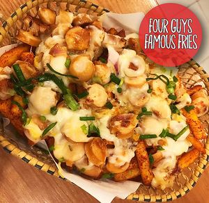 450 grams of our Fries topped with our homemade seasoning,Grilled onions, Hotdog, Cheese and our special Dynamite sauce.
That's the killer, and hard to finish!

All meat we use is Halal.
 at Four Guys Famous Fries in Koh Samui