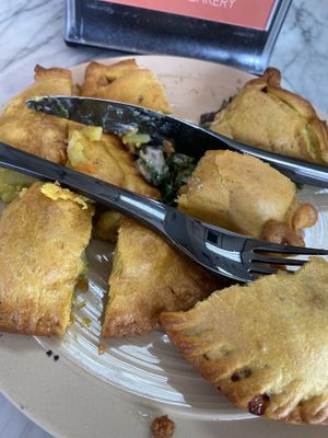 Every single empanada on the menu😬 at L'Artisane Creative Bakery in Coral Gables