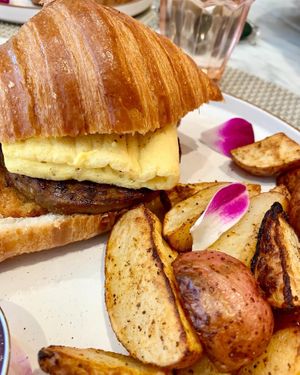 VTE croissant with hash brown, sausage patty, just egg and bacon at L'Artisane Creative Bakery in Coral Gables