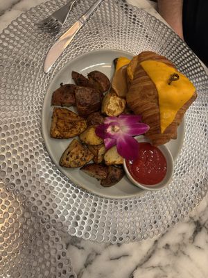 Croque Monsieur Croissant with Roasted potatoes .  at L'Artisane Creative Bakery in Coral Gables