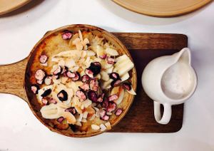 Vegan coconut and vanilla baked rice pudding with banana, freeze-dried blueberries and coconut milk at Ginger Brown Cafe in Hobart