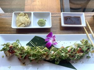 Christina’s Crispy: crispy rice topped with avocado, jalapeños, torched miso mayo, dot of siracha, green onion, cilantro, ponzu, sesame oil, crunchy garlic, soy glaze 💚  at Sushi Nekosan in La Jolla