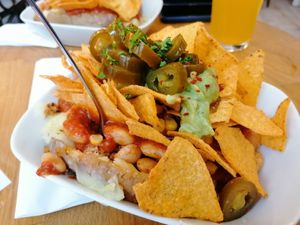 Mexicano potato - vegan chilli, sweetcorn, jalapeños, guacamole and topped with nachos. One of the best potatoes I've ever eaten at Erdapfel in Hamburg