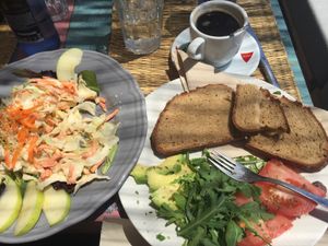 Salad w/cabbage, carrots, raisins, apples; bread with avocado, tomato, rucola at Grow Café in Tarifa