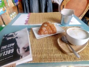 Vegan croissant and latte at Grow Café in Tarifa