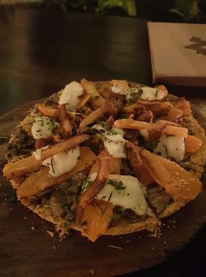 Gluten-free coconut-tapioca based pizza with cashew cheese, mushrooms, jackfruit sausage  at Zest Ubud in Ubud