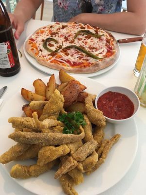 The 'fried seitan in corn jackets' with steak potatoes and the pepperoni pizza at Veganeria in Budapest