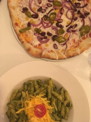 Pizza with jalapeños and spinach pasta  at Veganeria in Budapest