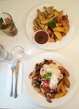 Top: fried seitan in corn jackets, with steak potatoes and spicy sauce
Bottom: roasted seitan with tomatoes, grilled with vegetables and vegan cheese, served with potatoes and roasted vegetables
As served in September 2018. at Veganeria in Budapest