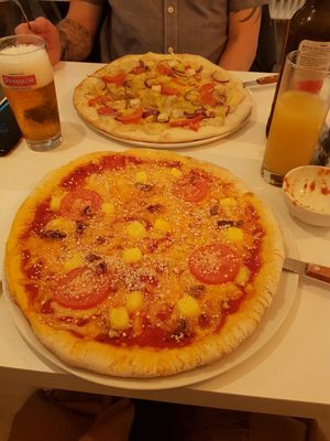 4 cheese pizza and tofu and garlic pizza in the background at Veganeria in Budapest
