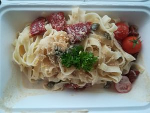 Tagliatelle with dried tomatoes, capers and cashew parmesan at Veganeria in Budapest
