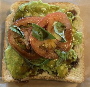 Tomato Basil Toast on white  at Atman Juice Bar and Cafe  in Watertown