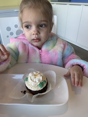 Happy toddler with her vegan cupcake  at Carina's Bakery in Beaverton