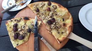 Pizza with thin potato slices, champignon, fresh rosemary, vegan cheese, olives at Café Piccolina in Aarhus