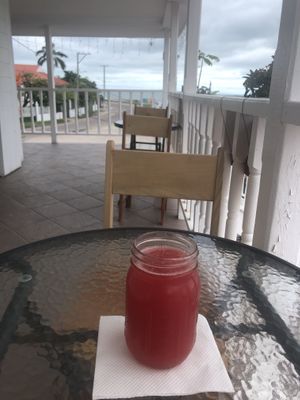 Watermelon Juice with the view in the distance of the Belize sigh  at Martha's Cafe Belize in Belize City