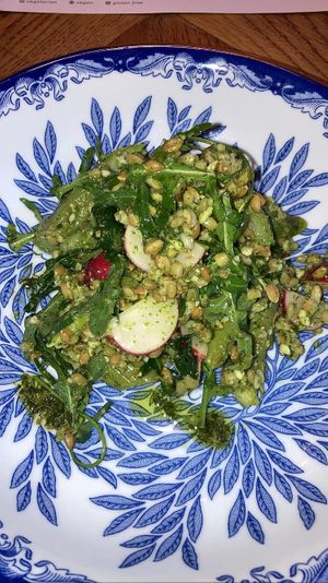 Spring salad: arugula, green asparagus, radish, wheat grains, pesto with kiwi flavor. Delicious!  at Karibu Cafe in Utrecht