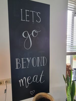 Let's go beyond meat - sign on wall at Black & White Kafe in Breda
