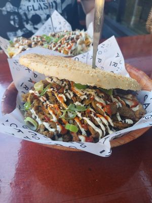 Kebab pieces with garlic and sriracha sauce on a sesame seed bun. at Ping Pong Parck in Amsterdam