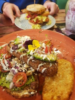 Avocado on toast (and a burger in the background) at The Vegan Shack in Richmond