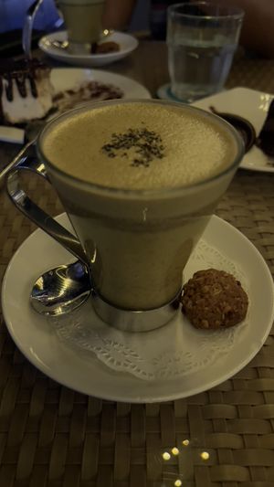 Turmeric ginger soy latte (note the little biscuit is vegan too)  at Privé - Keppel Bay in Central Singapore