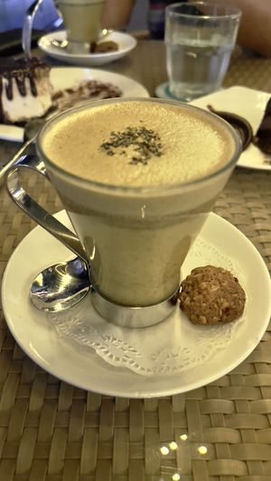 Turmeric latte  (the biscuit is also vegan)  at Privé - Keppel Bay in Central Singapore