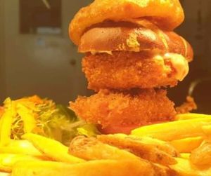 Vegan burger.
Irn-Bru battered crispy sweet potato topped with cheezy sauce, in a pretzel bun with lettuce, tomato, hand-cut pickle, mayo. Served with hand-cut chips & onion ring. at Creagan Inn in Appin