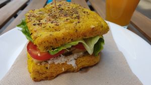 Focaccia bread with chickpeas burger, vegan mayo, tomato and lettuce. at Ovita in Bari