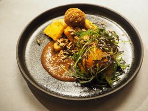 Pumpkin, miso, bitterbal, mole, roasted, and mustard leaf at Yerba in Amsterdam