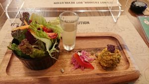 Starter for lunch course: salad, health drink shot, pickled vegetables and hummus at Premarché Alternative Diner in Kyoto