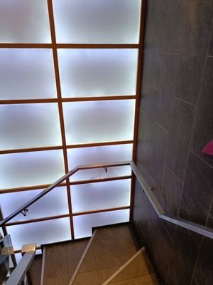 Stairs to seating area at Itsu - Neal St in London