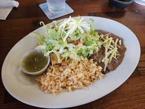 Two tacquitos. (They're in there under the veggies) at Cocina Michoacana in Oakdale