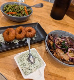 Spicy beans, ulundu vada, eggplant moju, green chilli and coconut sambal at Spice Garden in Nightcliff