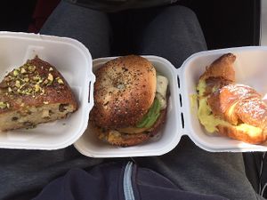 my order: croissant w lemon crema; a pistachio maple torta; everything bagel w just egg, violife mozz, avocaodo, and more at Fermento in Long Beach