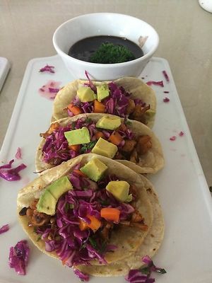 Black Bean & Butternut Squash Tacos with avocado, grilled onions and pickled cabbage slaw, served with a side of black beans. at Iguana Juan's in San Pedro
