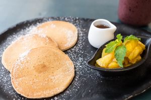 American style pancakes with various fruits and maple syrup. at Nourish Cafe in Bangkok