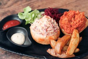 BBQ Jackfruit Burger with potato wedges, creamy garlic coleslaw, salad and dips at Nourish Cafe in Bangkok