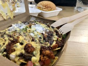 Black bean frijoles nachos with added vegan chorizo, + breakfast bap in background at Vutie Beets in Letchworth