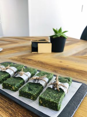 Energy Raw Hemp Algae Bars with Spirulina for a perfect healthy snack. Pistachios, Pumpkin seeds, Mandarin, Dates, Hemp Hearts, Shredded coconut and Spirulina  Come and check out our fridge for all the delicious flavors at Gfeels Cafe in Tenerife