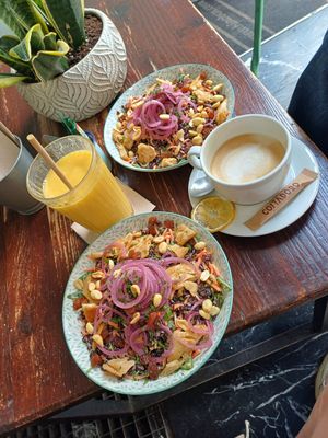 bowls venere with extra vegan chicken, mango smoothie and coffee with oat milk at Kino in Barcelona
