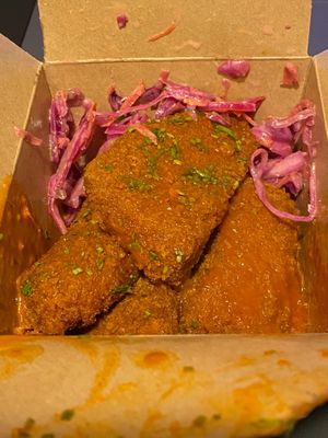Seitan Buffalo wings in hot sauce and coleslaw at Rudy's Dirty Vegan Diner in North West London